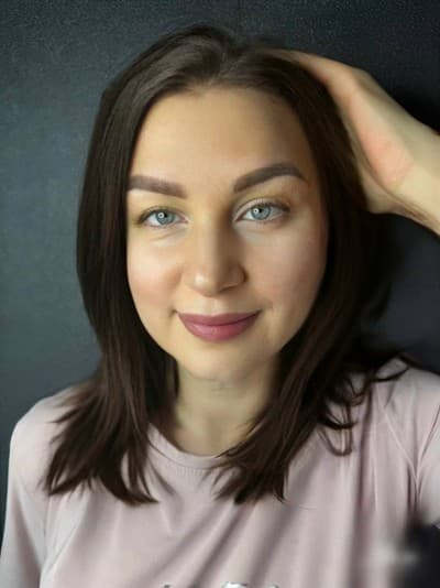 Image of a woman showcasing permanent makeup on brows and lips.